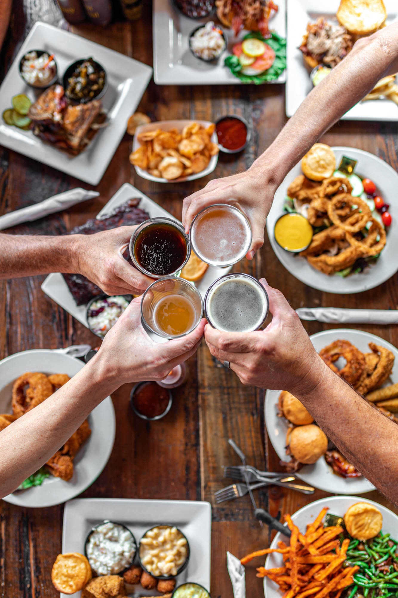 A shared Smokin’ Dave’s table with food and drinks